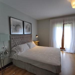 - une chambre avec un grand lit et une table en verre dans l'établissement Casa De Campo Clara, à Santa Cristina