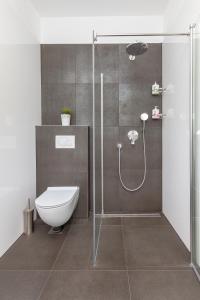 a bathroom with a toilet and a glass shower at Nest Apartment in Split