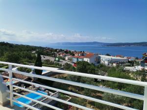 a view from a balcony of a city and the water at Apartments Permida in Dramalj