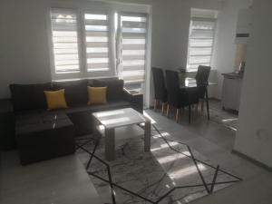 a living room with a couch and a table at Apartman Nea in Sanski most