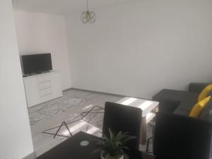 a living room with a couch and a tv at Apartman Nea in Sanski most