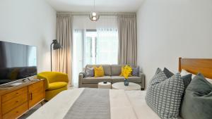 - une chambre avec un grand lit et un canapé dans l'établissement Modern Regency Staycation, à Al Qurayyah