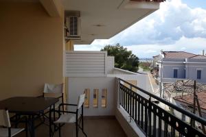 a balcony with a table and chairs on a building at Alasrooms Γ1 in Missolonghi