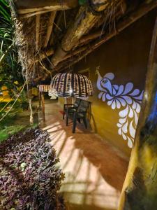 a room with a bench and a painting on the wall at WildDunes Eco Resort Konark in Bālighāi