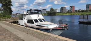 a boat is docked at a dock in the water at Ferienhaus Hafen 17 in Hörstel