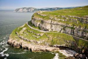 an island in the ocean with a road on it at Cludfan (Cosy Place) - in the heart of Llandudno in Llandudno