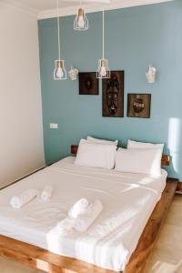 a bedroom with a large white bed with towels on it at Sole'n Blu in Kaş