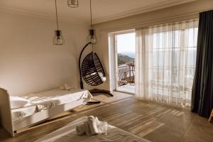 a bedroom with a bed and a large window at Sole'n Blu in Kaş
