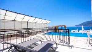 a balcony with a pool and a table and chairs at Sole'n Blu in Kaş