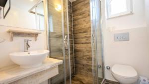 a bathroom with a toilet and a sink and a shower at Sole'n Blu in Kaş