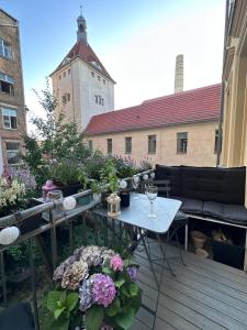 een patio met een tafel en bloemen op een balkon bij charming and cozy apartment in Berlijn