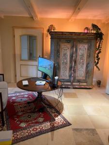 a room with a table with a computer on it at Ferienhaus am Hochgern in Unterwössen