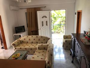 a living room with a couch and a table at Dina House in Himare