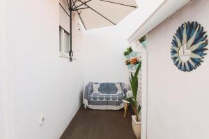 a hallway with a blue and white chair in a room at duArteLoft in Sines