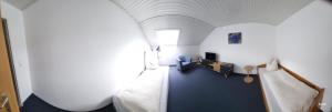 Zimmer mit blauem Boden und weißer Decke in der Unterkunft Erd´s Hoimatle Ferienwohnung in Jungholz
