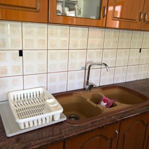 a kitchen sink with a dish drying rack in it at Dina House in Himare