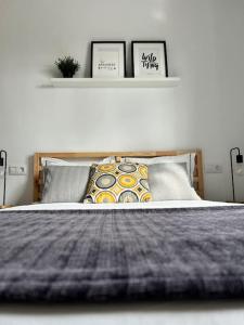 a bedroom with a large bed with two pillows at Ático casa de invitados Bluemoon in Las Lagunas