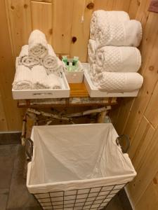 two baskets of towels and a pile of towels at The croquet cabin your year round romantic escape in Boulder Junction