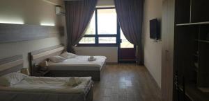 Voodi või voodid majutusasutuse Cross Resort Hotel toas