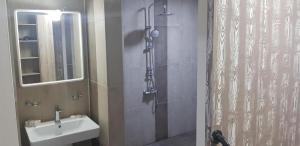 a bathroom with a shower and a sink and a shower at Cross Resort Hotel in Yerevan