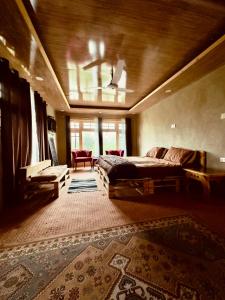 a large bedroom with a bed and a rug at Orgventure Resorts Skardu in Skardu