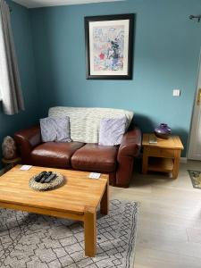 a living room with a couch and a coffee table at 'Kodi's Place' Well appointed 1 bedroom apartment with excellent transport links and free Wi-Fi in Whiteabbey