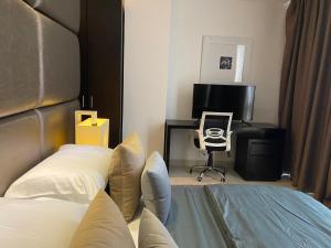 a bedroom with a bed and a desk and a chair at Platinum 1 in Colombo