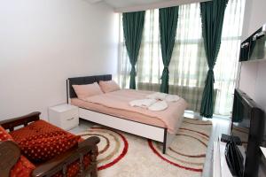 a bedroom with a bed with two towels on it at Hotel Xhema in Pristina
