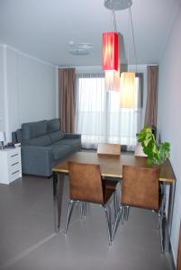 a living room with a dining table and a couch at Aparthotel El Faro in Cullera