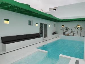 a swimming pool in a building with blue water at Villa Tagoror in Tiagua