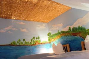 a bedroom with a painting of a river on the wall at Biberbau in Reinsfeld