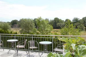 a patio with chairs and tables on a balcony at Biberbau in Reinsfeld