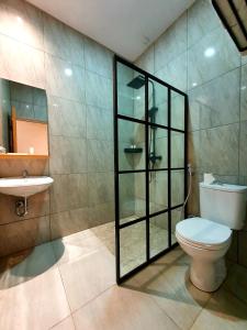 a bathroom with a toilet and a sink at Little Tokyo in Yogyakarta