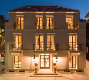 a house with a lit up facade at night at Argostoli Essence Suites in Argostoli