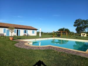 a large swimming pool in the yard of a house at THE RANCH Apartment 3 Capalbio in Pescia Romana