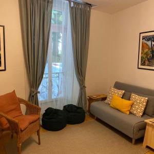a living room with a couch and a window at Newly Renovated Ground Floor Apartment close to Thermes in Luchon