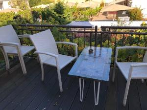 two chairs and a table on a deck at Künstlerapartment Potsdam in Potsdam