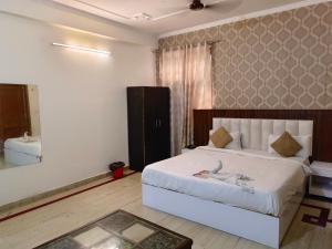 Postel nebo postele na pokoji v ubytování Viraj Guest House