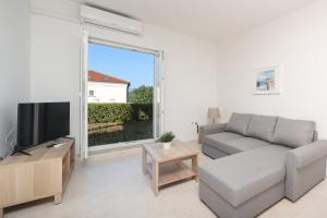 a living room with a couch and a large window at Sea view by Moro in Malinska