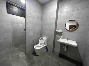 een persoon die een foto neemt van een badkamer met toilet en wastafel bij MySoho-Armadale,Gala City in Kuching