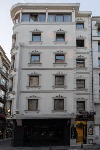 a tall white building with many windows at Felicity Hotel İstanbul in Istanbul