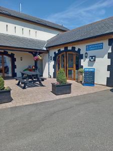 a building with a picnic table in front of it at Lake District Modern Static Caravan in Maryport