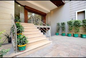 a staircase with potted plants on the side of a building at Hotel King's way in Amritsar