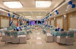 a banquet hall with blue and white tables and chairs at Hotel King's way in Amritsar
