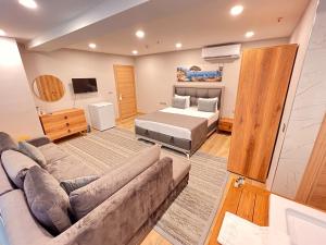 a living room with a couch and a bed at Old Town Point Hotel & Spa Antalya in Antalya +37 photos