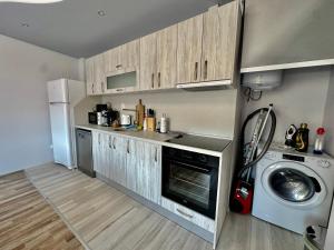 een keuken met een wasmachine en een wasmachine bij Central Vista Apartment by LMG in Sofia