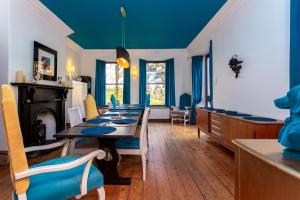 a dining room with a long table and blue ceilings at St Marks Stays in Sedbergh