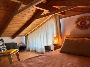 a bedroom with a bed and a wooden ceiling at Jordan River Village in Menaẖemya