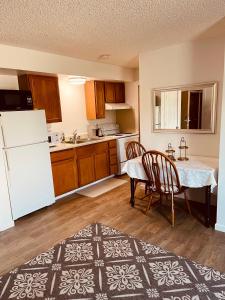a kitchen with a table and a white refrigerator at North Star Place Apt 8 in Fairbanks