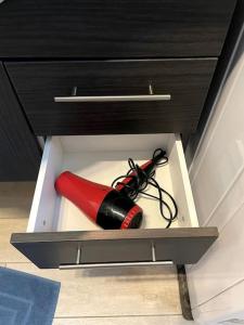 a red and black fire extinguisher in a drawer at Maisonette cibeno in Carpi